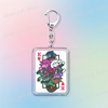 A silver keychain featuring a design of Deltarune chibi characters holding poker cards.