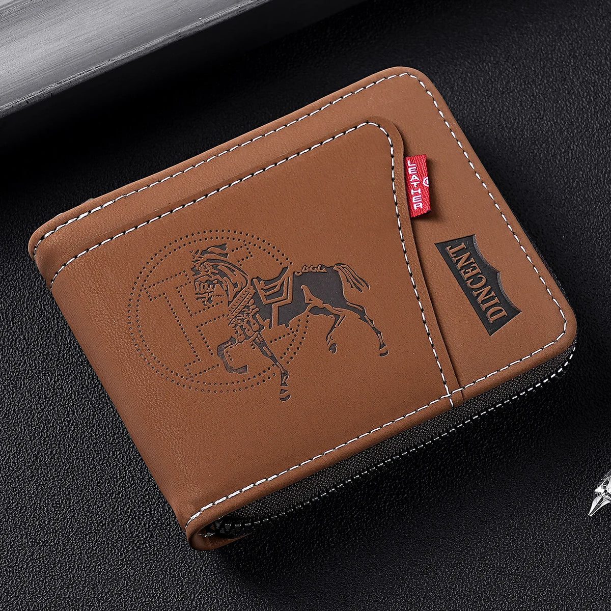 A brown leather card clip wallet with a debossed silhouette of a horse and the word DIANCENT on the cover.