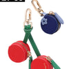 Two red cherry fruit shape coin purse keychains with gold hardware and blue fabric.