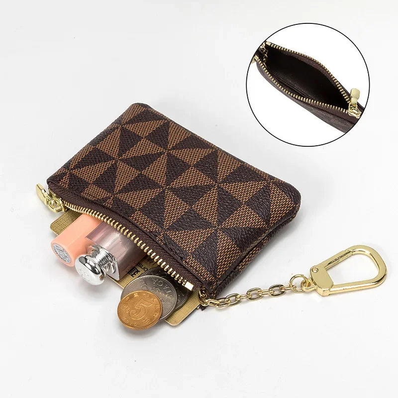 A brown geometric mini coin purse with a zipper and gold chain is shown, including an inset view of the interior.