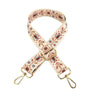 Sangle en cuir beige réglable avec motif floral et quincaillerie dorée.