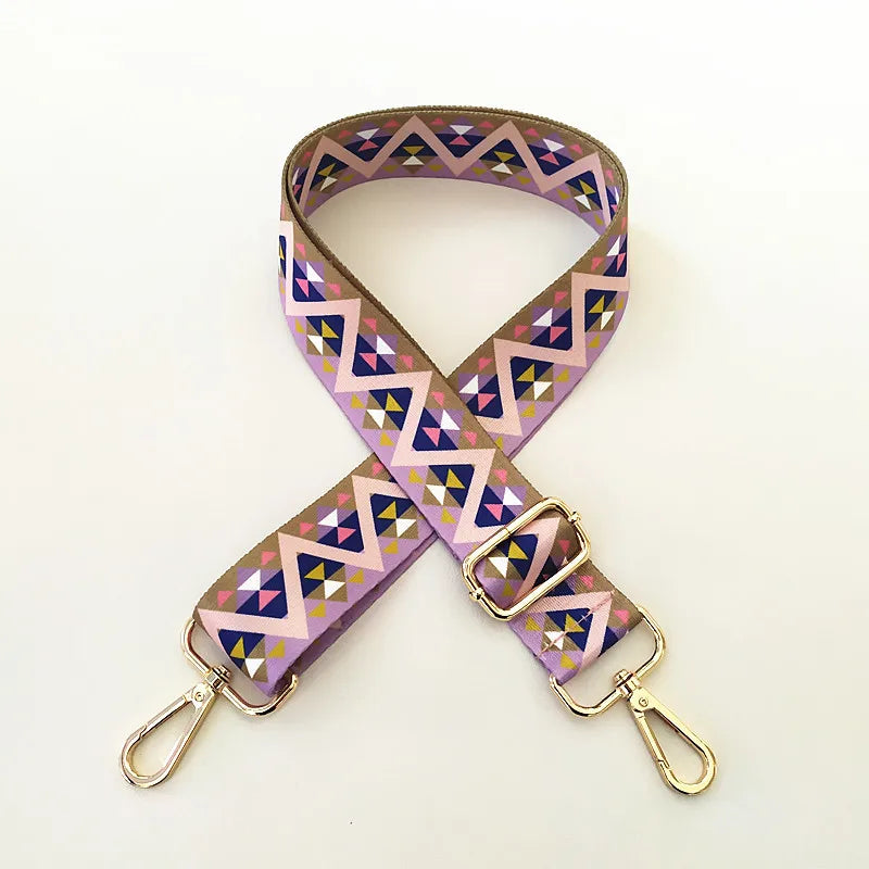 Sangle ajustable en cuir à l'épaule à motifs géométriques violets, roses et bleus.