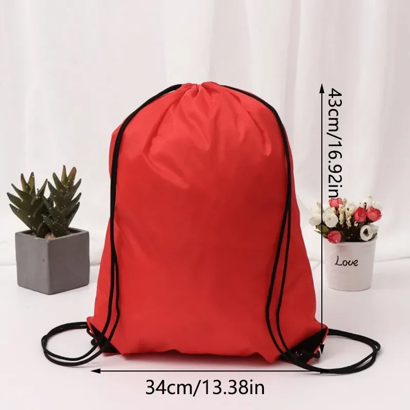 A bright red gym drawstring backpack with black trim and multiple pockets, shown next to a potted plant and a small flower.