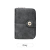 A dark grey leather wallet with a zipper closure and a metal accent.