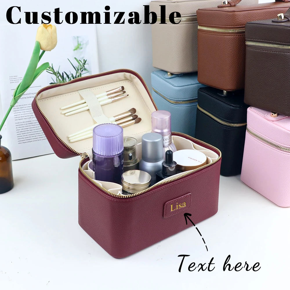 A customizable PU leather makeup bag in maroon color with compartments and tools displayed on a white surface.
