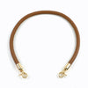 A brown leather strap with gold metal buckles, used as a replacement bag handle.