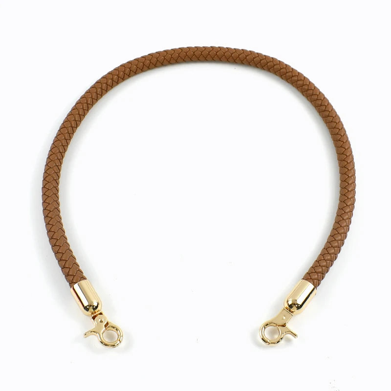 A brown leather strap with gold metal buckles, used as a replacement bag handle.