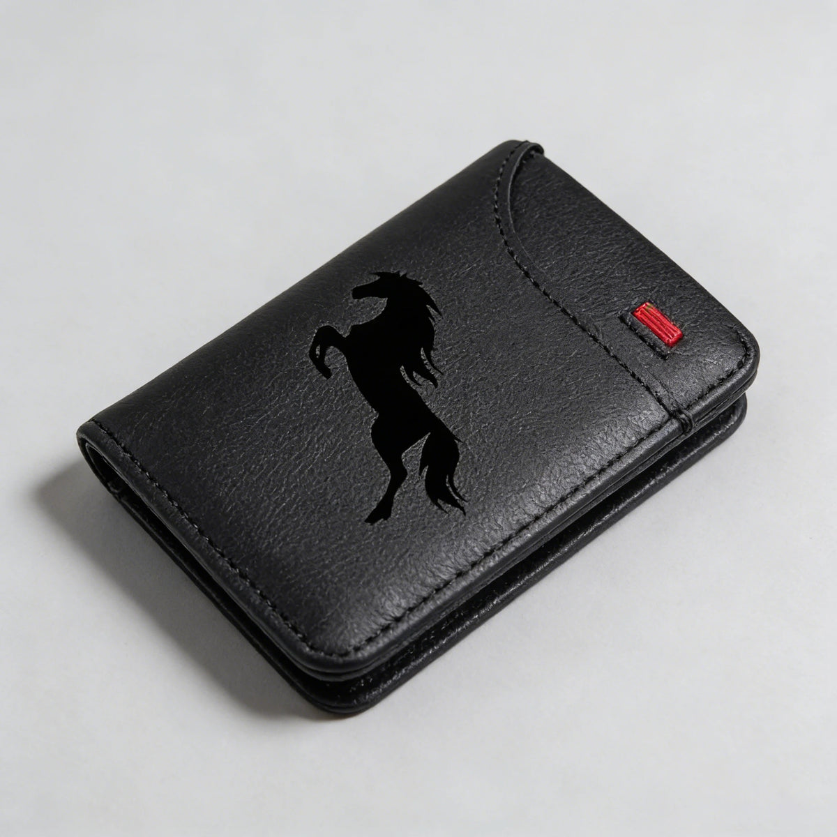 Black faux leather card holder wallet with a silhouette of a horse on the front