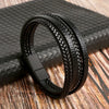 A black multi-layer leather bracelet with textured beads resting on a dark surface.