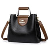 Sac bandoulière vintage en cuir noir à multiples poches avec garniture marron et logo gravé en or.
