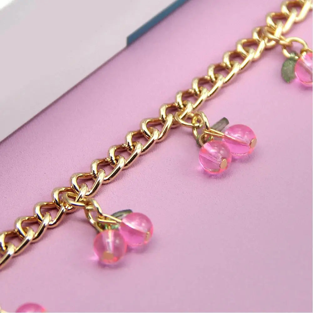 Gold chain necklace with pink glass beads used as decorative pendants