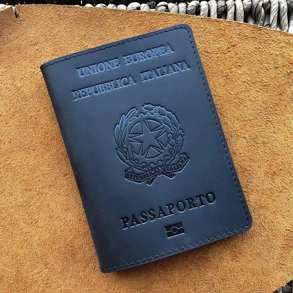 A dark blue leather passport holder embossed with the text UNIONE EUROPEA REPUBBLICA ITALIANA and PASSAPORTO placed on a brow