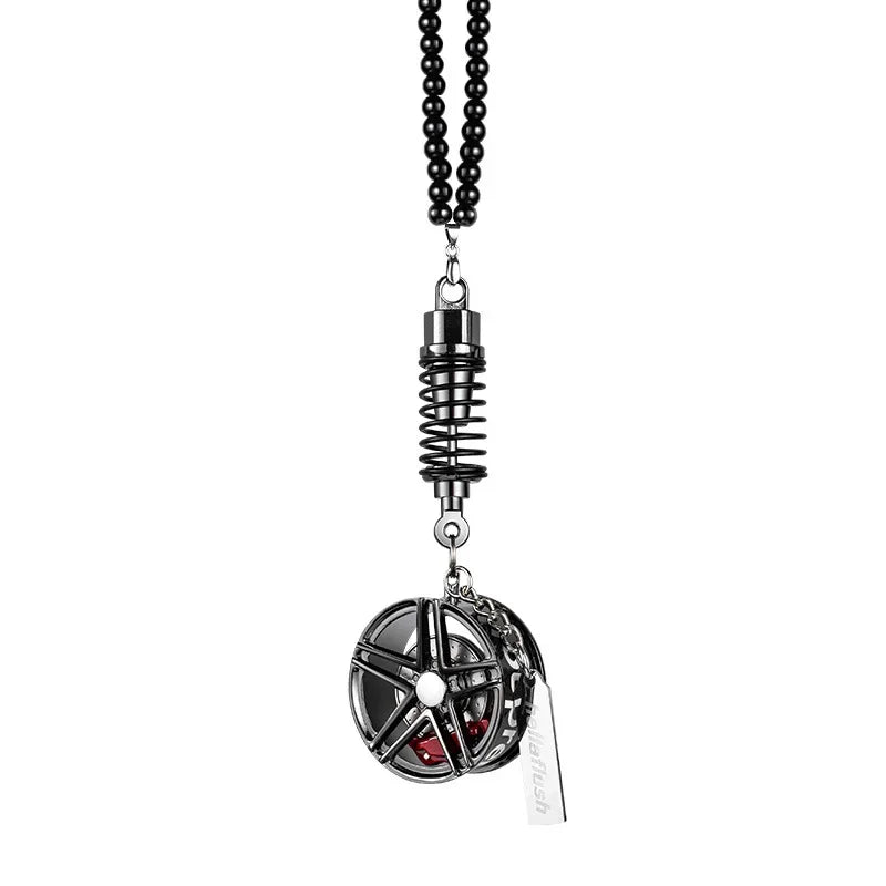 A pendant featuring an alloy wheel hub brake disc and rearview mirror design.