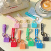 A collection of colorful silicone heart beach bag keychains displayed on a light surface.