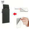 A black metal RFID blocking card holder with multiple slots and an adhesive card being applied to a surface.