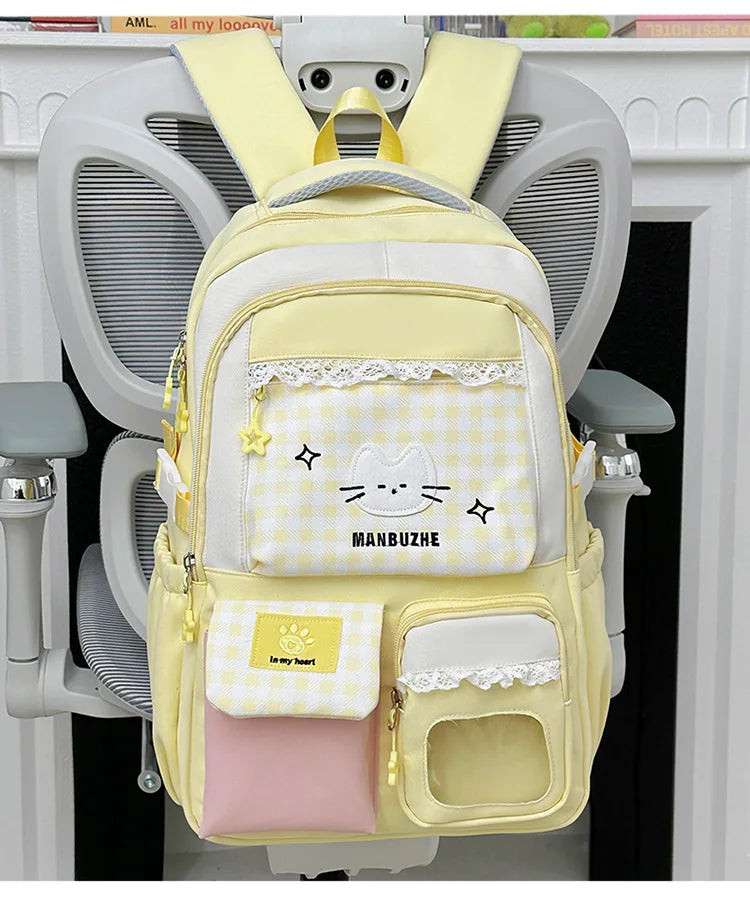 A yellow and white Manbuzhe backpack hanging on a white coat rack.