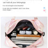 A pink lightweight nylon travel bag is open, showing various fitness and travel items inside.
