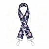 A navy blue and white polka dot nylon shoulder strap for bags and purses.