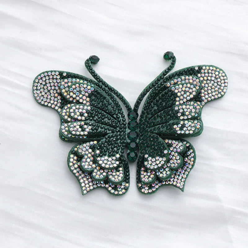 A dark green rhinestone butterfly applique sticker with intricate detailing.