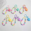 A collection of colorful bead keychains featuring hearts and bows on O-ring clips.