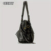 A black vintage washed leather tote bag with a flap closure and gold hardware.