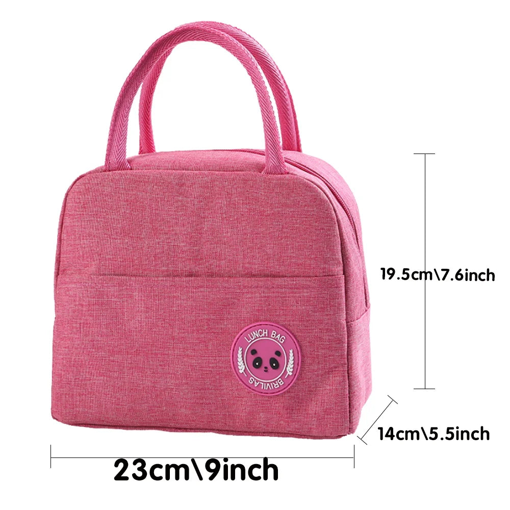 A pink insulated canvas lunch bag with pink handles and a circular design on the front.