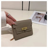 A beige multi-slot card holder is shown being held by a hand on a white surface.