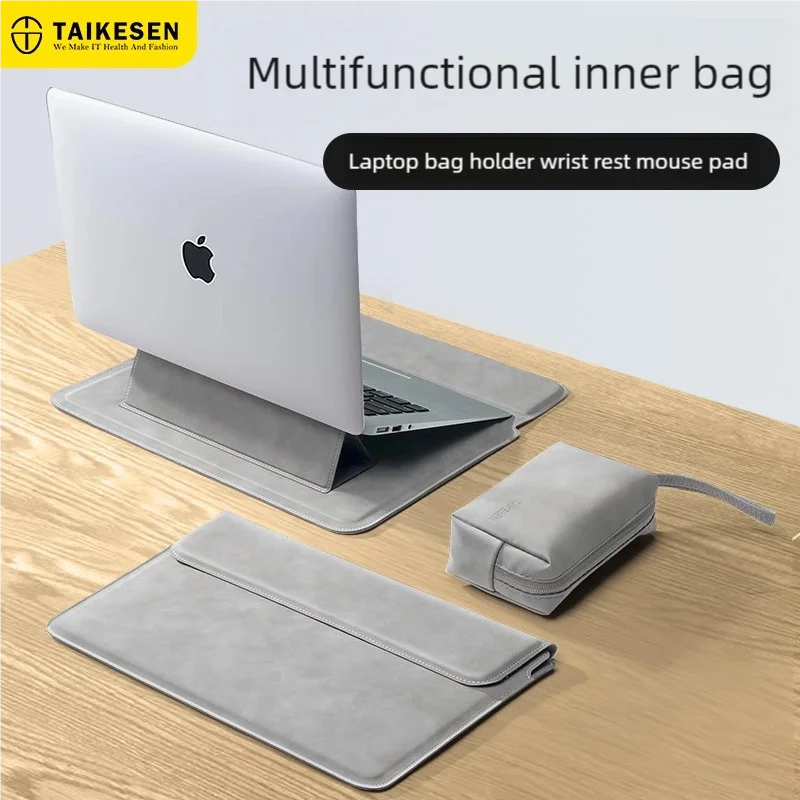 A gray multifunctional inner bag is shown with a silver laptop resting on it, next to a larger gray sleeve.