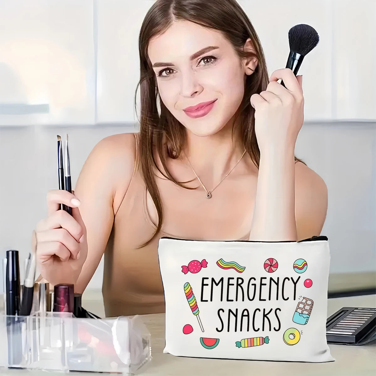 A woman holds an emergency snacks pouch featuring colorful candies and snacks.