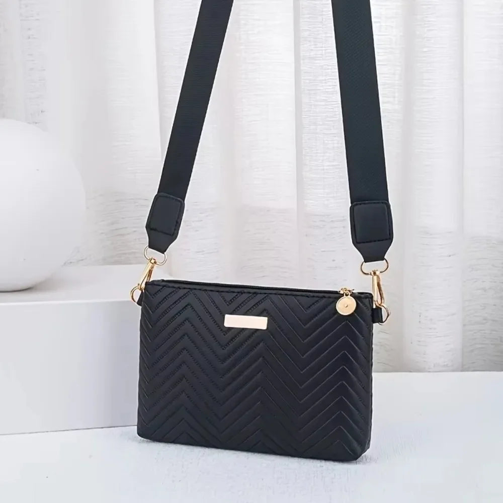 Black quilted leather crossbody bag with gold hardware and black strap