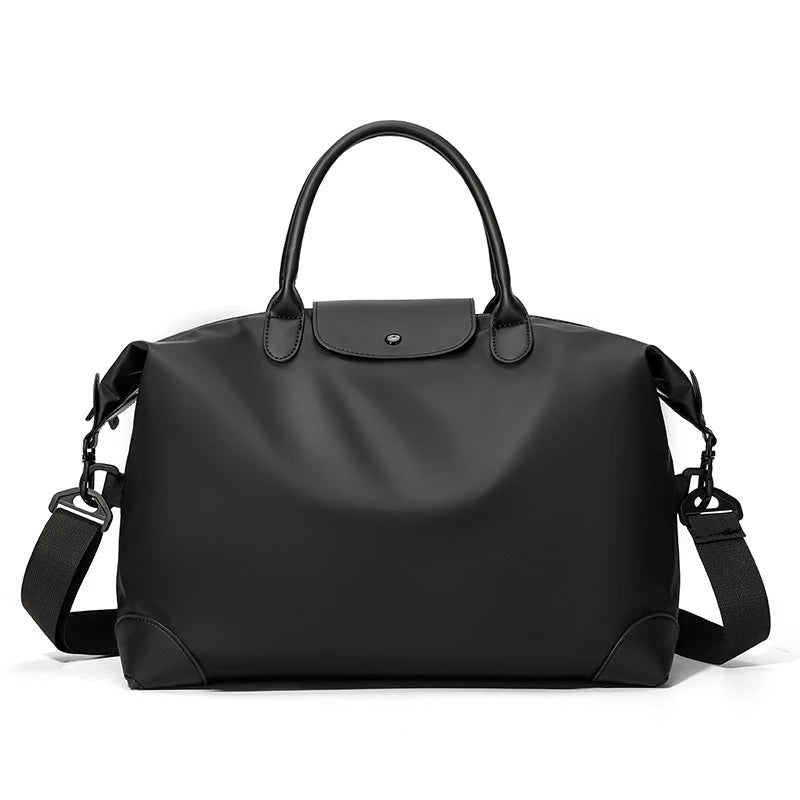 A black durable nylon travel duffle bag with leather handles and straps.
