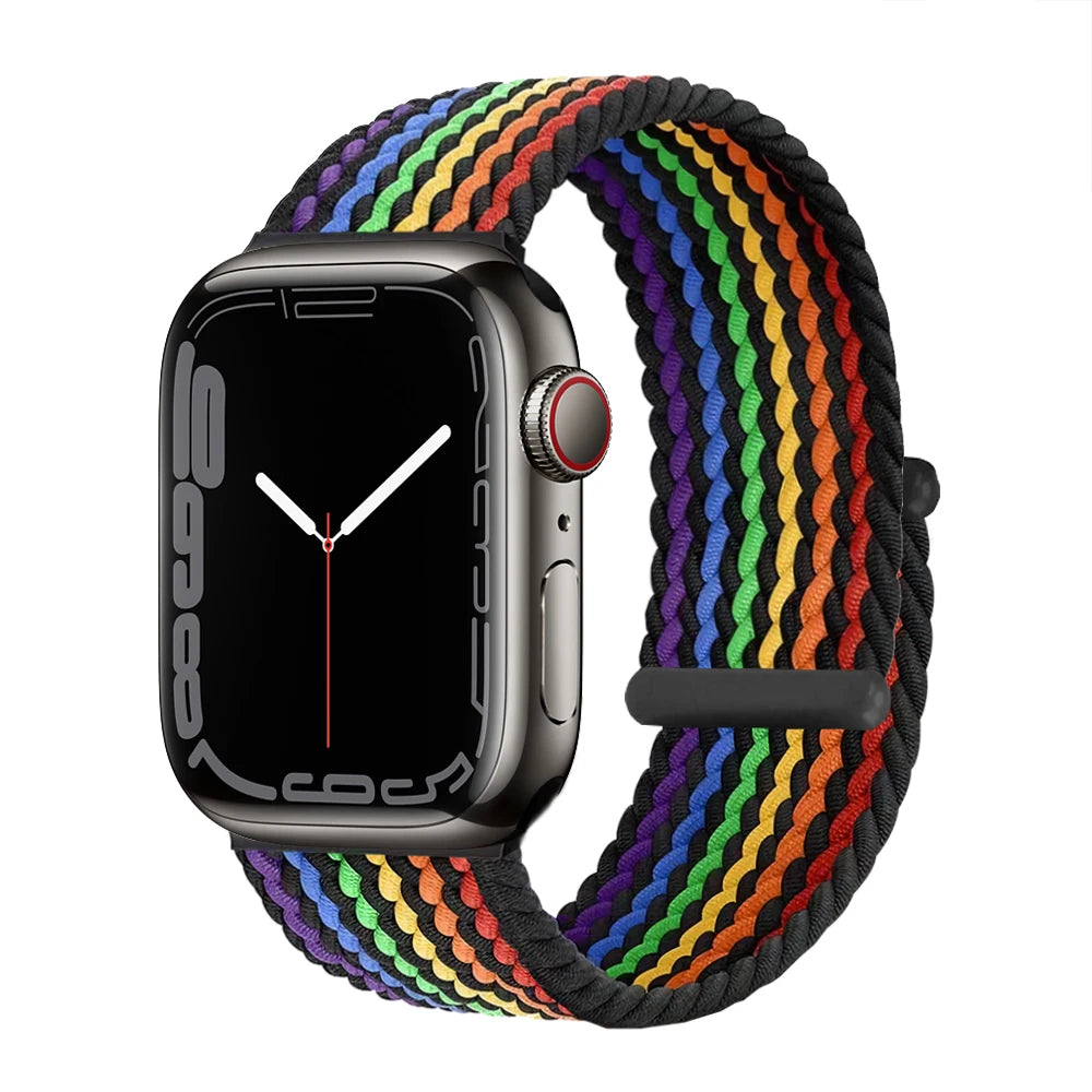 Apple Watch with a multi-colored braided stretch band worn on the wrist.