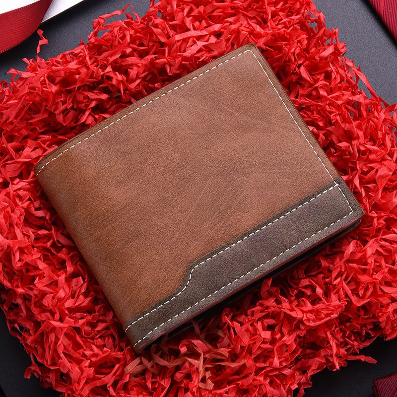 A brown PU leather men's wallet with a stitched edge is placed on a vibrant red, shredded fabric background.