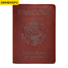 A dark red genuine leather passport holder embossed with the United States of America eagle design.