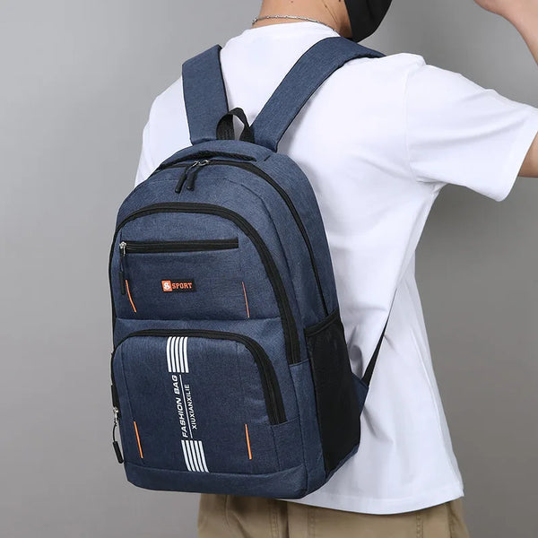 A navy blue lightweight commuter backpack worn by a person, featuring black accents and white stripes.