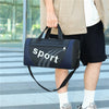 A person is holding a dark blue and black sports backpack with a strap, standing outdoors.