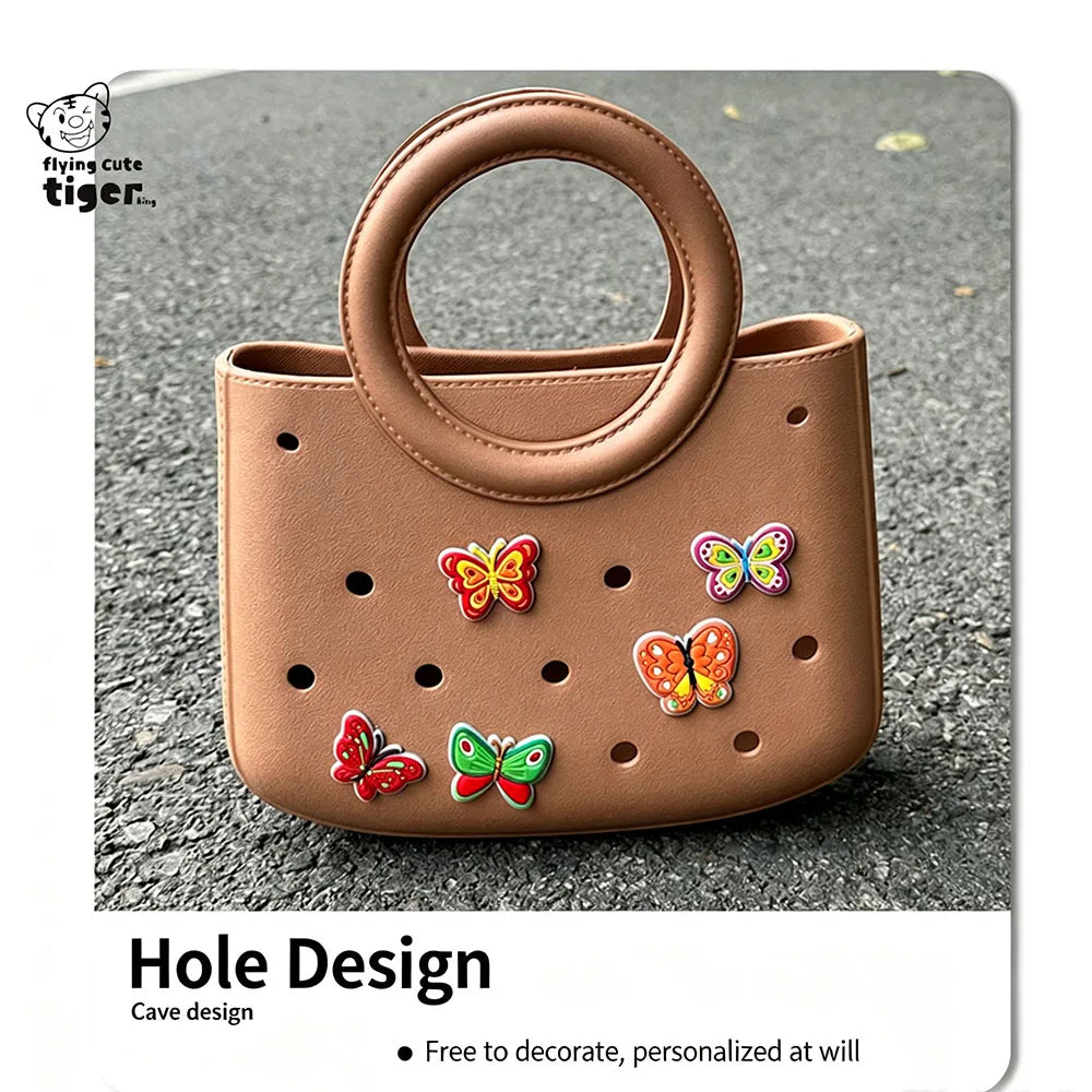 A round, tan PVC handbag with a handle and decorative butterfly holes on the surface.