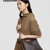 A woman holds a brown geometric embroidery hobo shoulder bag.