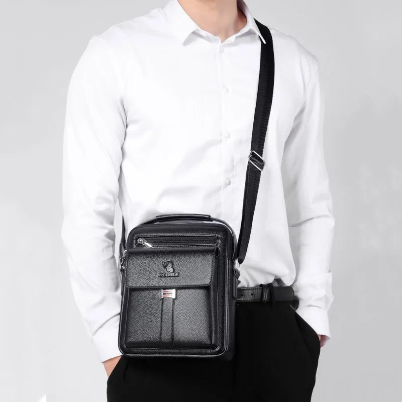 A black vintage PU leather crossbody messenger bag worn by a man in a white shirt.
