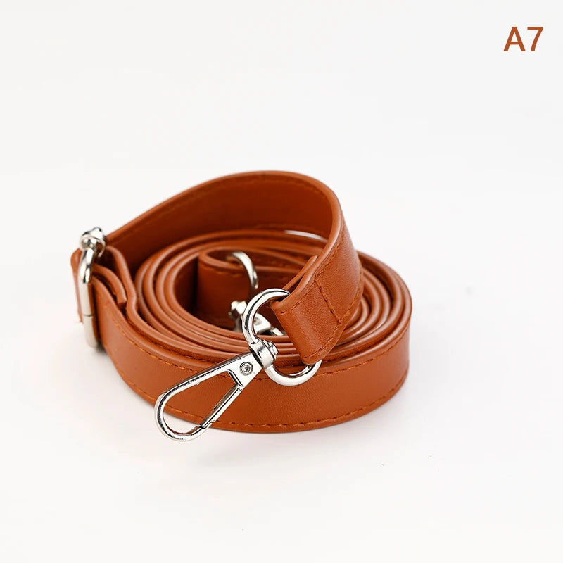 A brown PU leather strap coiled and featuring a silver clasp for an adjustable crossbody bag.