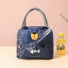 A dark blue insulated lunch bag with a handle is shown being filled with water, featuring a fish design and the text Have a G