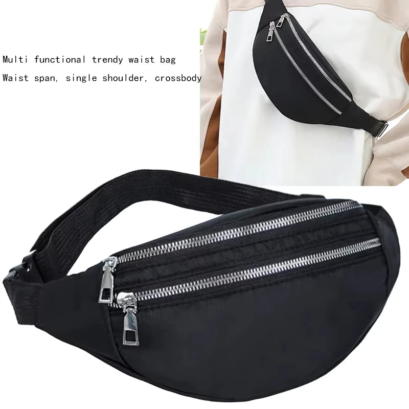 Black multi functional trendy waist bag with a zipper and strap shown against a white garment.