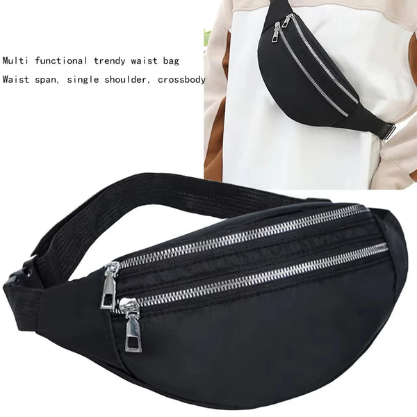 Black multi functional trendy waist bag with a zipper and strap shown against a white garment.