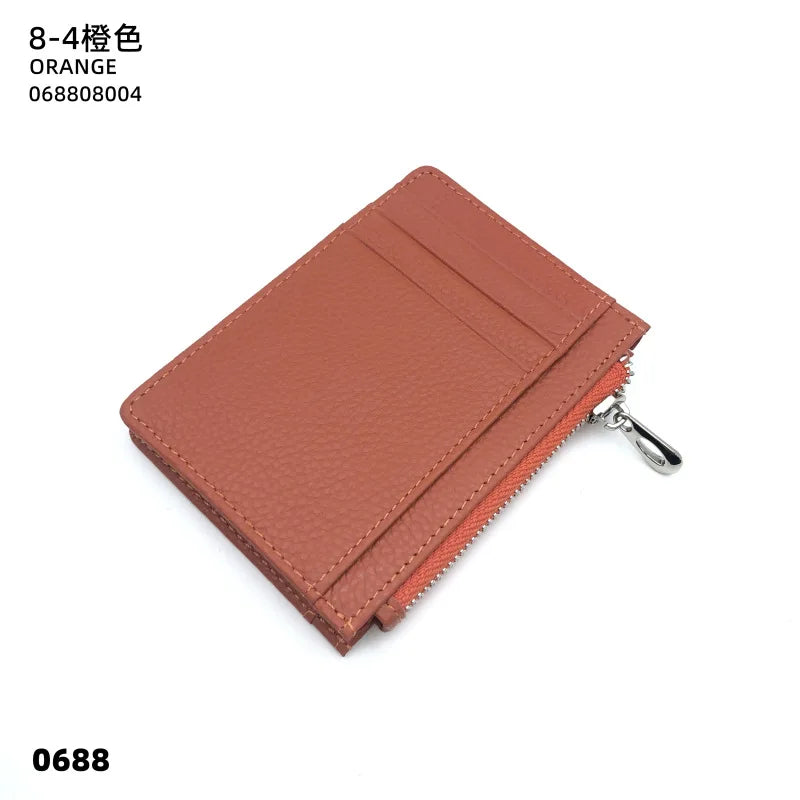 A genuine leather card holder in orange color with a silver zipper closure.