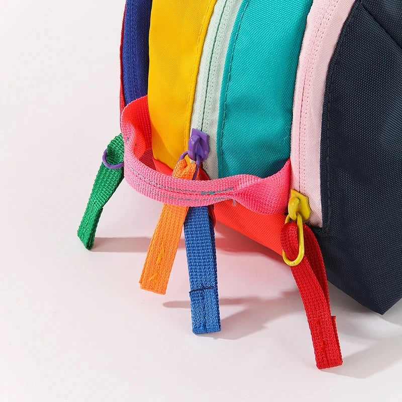 A colorful lightweight travel makeup bag featuring multiple bright fabric colors like yellow, green, pink, and blue.