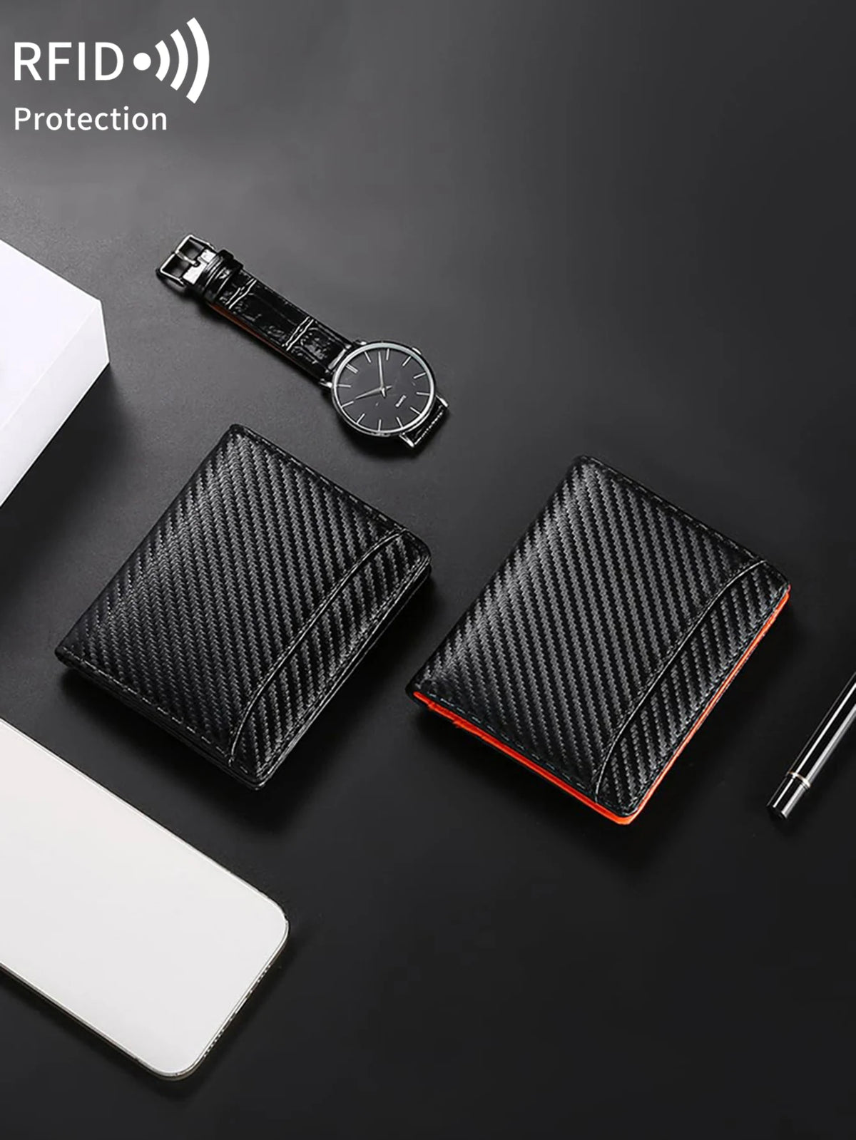 A black RFID-blocking bi-fold wallet with a carbon fiber texture is shown next to a wristwatch and a white smartphone.