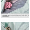 A light green duffel bag showing features like a front zipper and a separate section for wet and dry separation.