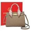 A beige genuine leather shoulder bag with a quilted texture and white patterned handles.