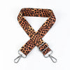 A brown leopard print adjustable crossbody strap with silver hardware.