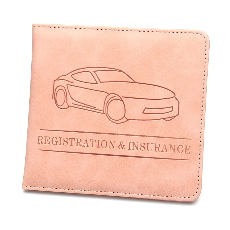 A light peach leather glove box wallet with a line drawing of a car and text reading Registration & Insurance.